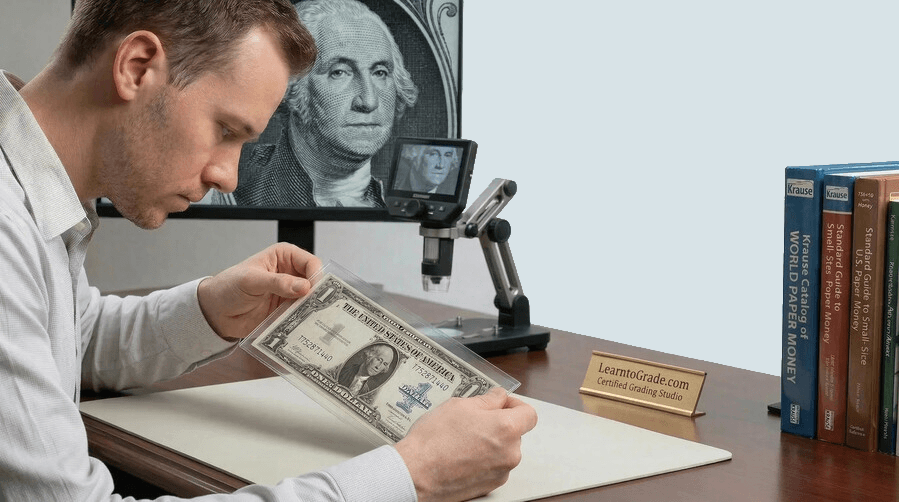 a man is grading a banknote at his desk